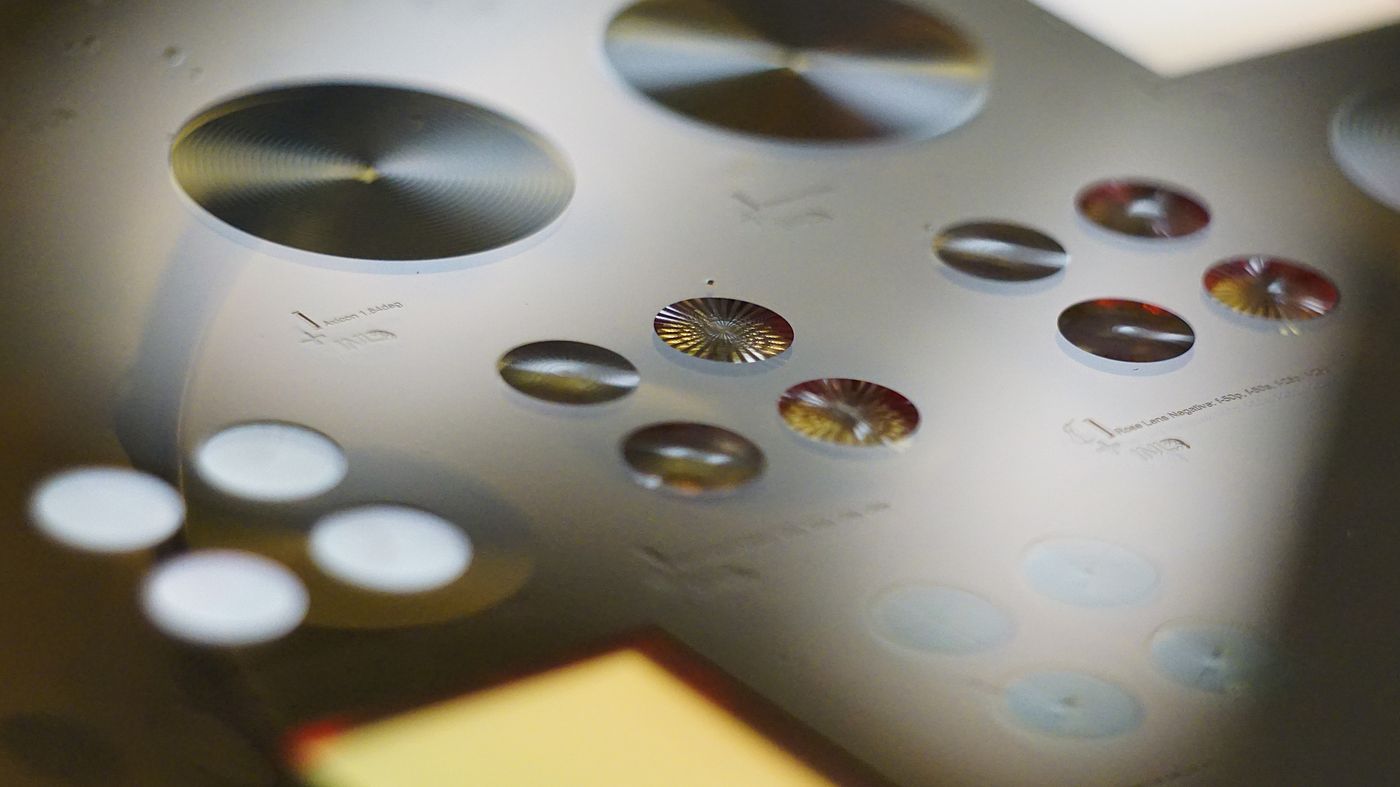 Close-up of fabricated diffractive optics on a wafer: axicons, lenses and holograms side by side.